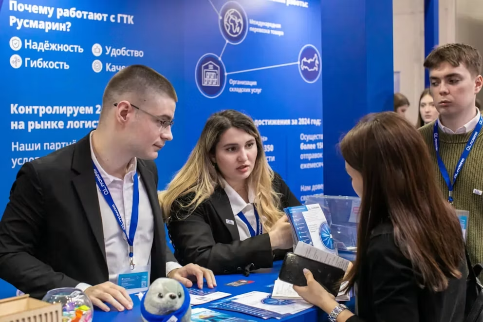 Business professionals networking and talking at a corporate exhibition stand